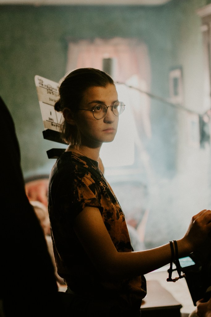 Jenna Castillo checking the light on a hazy set