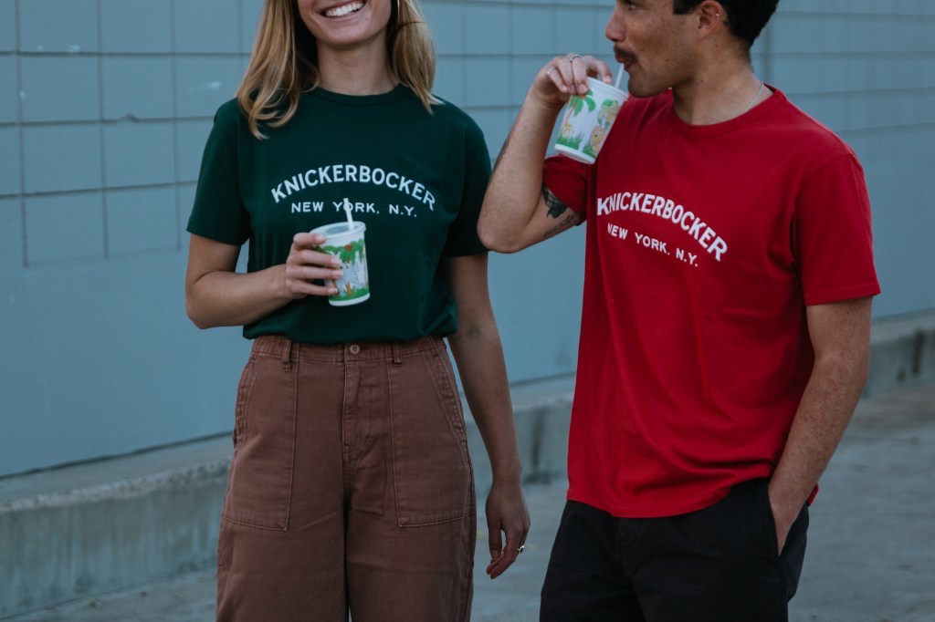 Syd and Keally drinking slushies in red and green Knickerbocker tees
